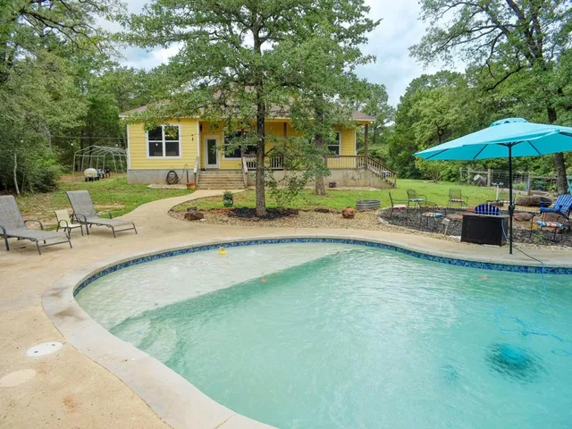 swimming pool view with a seating space