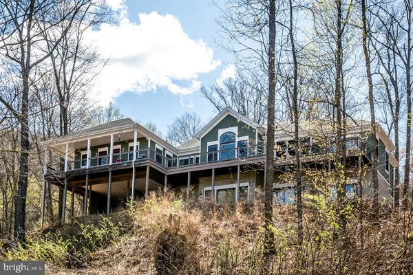 a view of a house with yard and sitting area