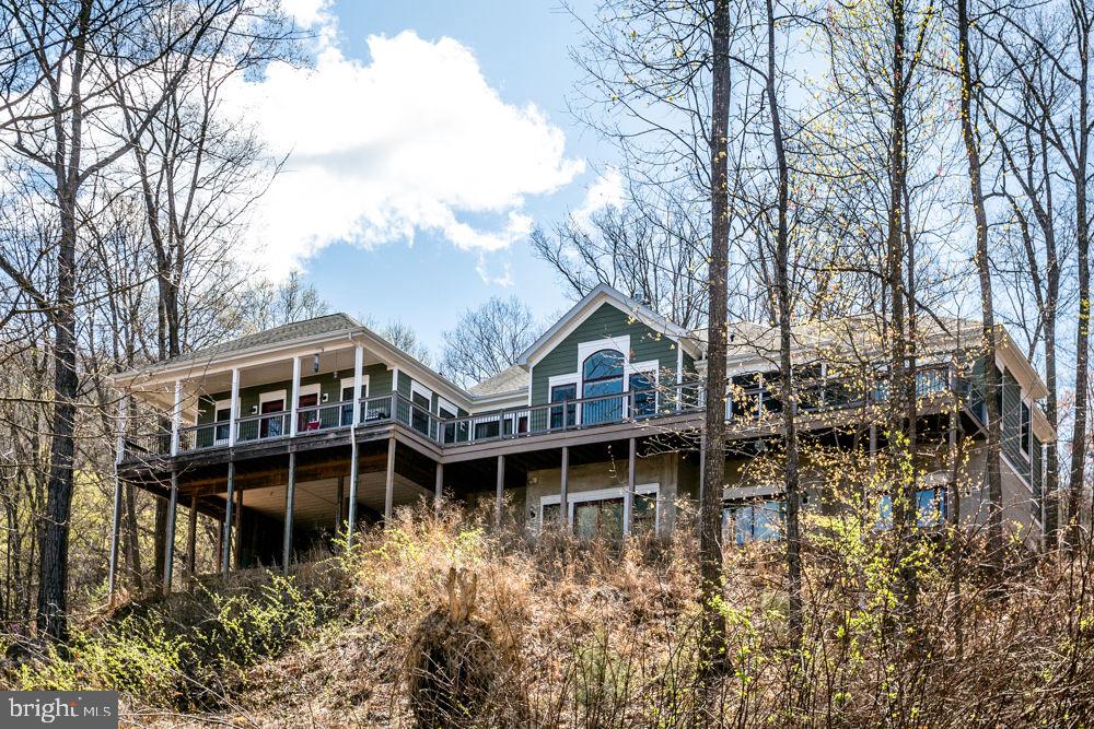 a view of a house with yard and sitting area