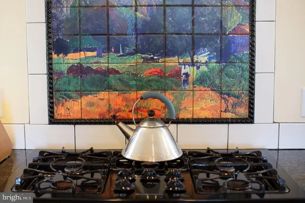 a kitchen with a sink and a stove next to a window