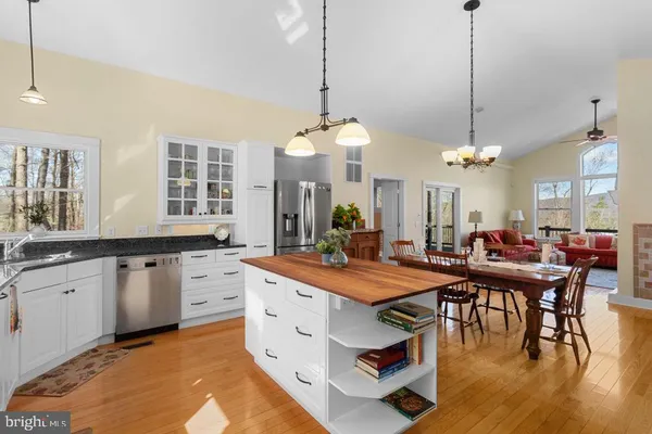 a large kitchen with a table and chairs