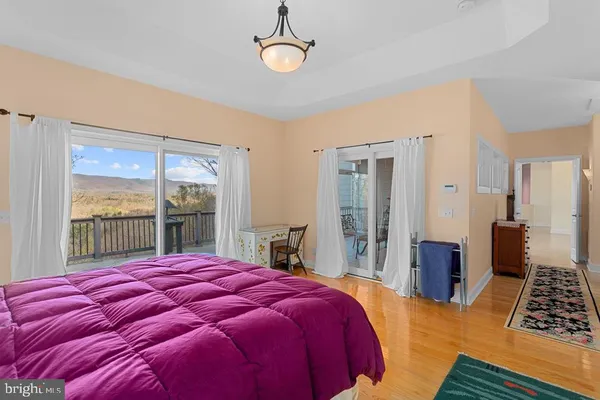 a bedroom with a large bed and a large window