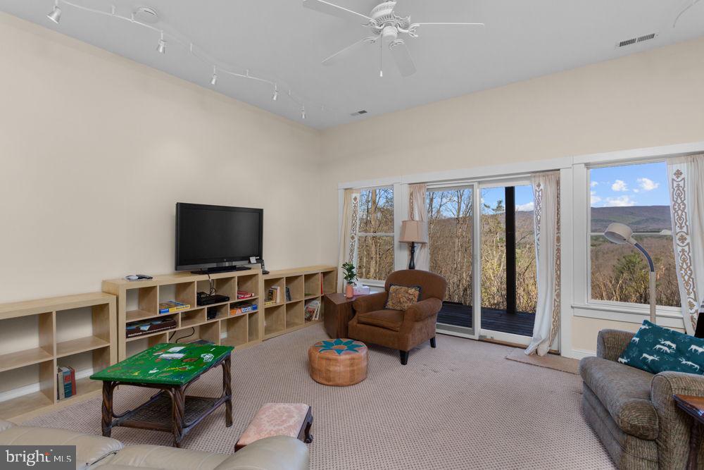 9586 Brunk Spring Lane Broadway, VA 22815 - Photo 35 of 57 a living room with furniture and a flat screen tv