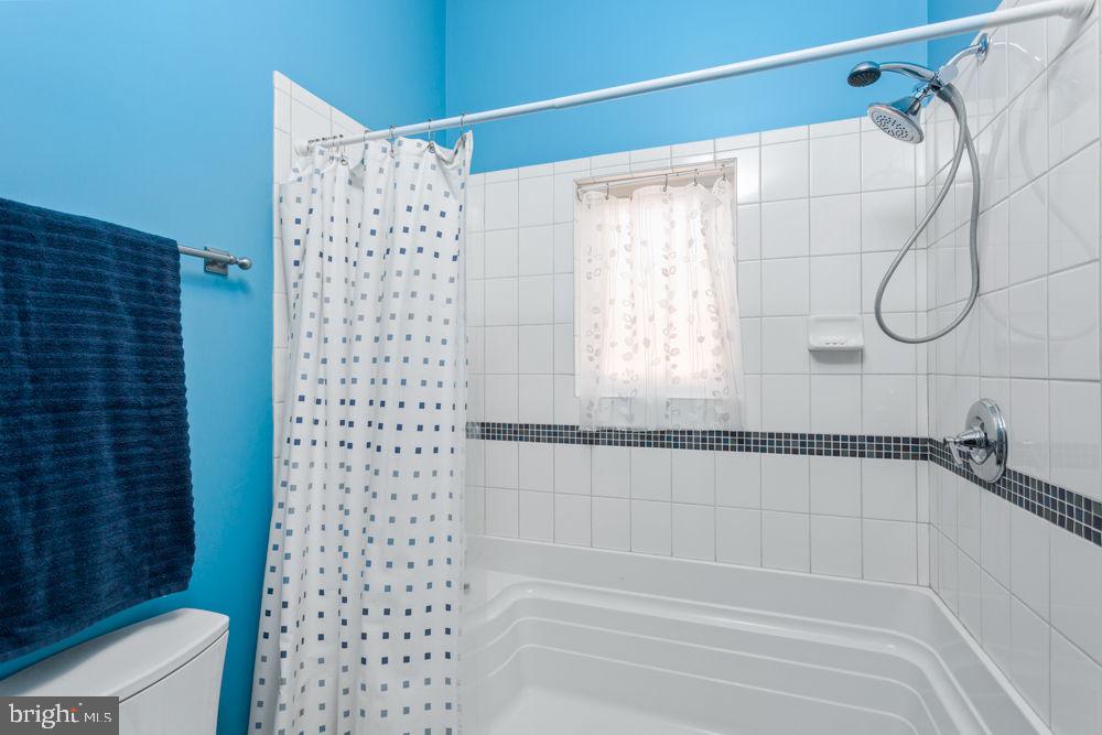 9586 Brunk Spring Lane Broadway, VA 22815 - Photo 41 of 57 a bathroom with a shower and a bathtub