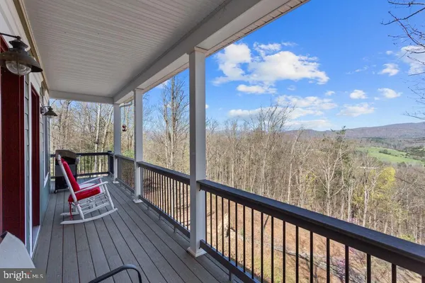 a view of a balcony with wooden floor and fence