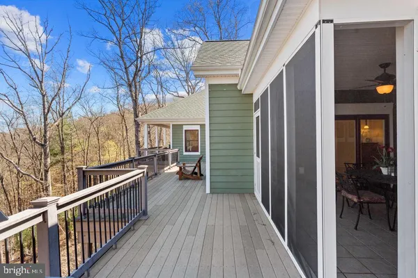 a view of a house with backyard and deck