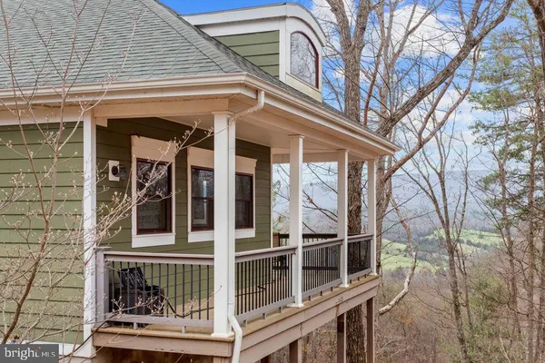 a front view of a house with a garden and yard