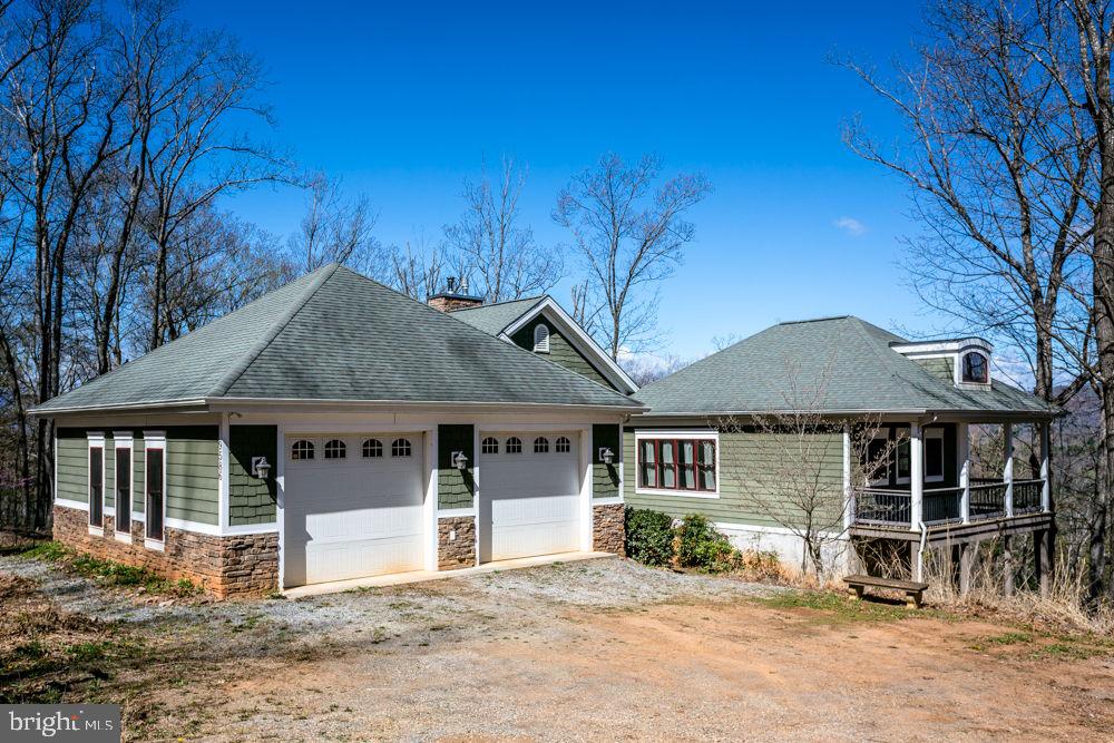 9586 Brunk Spring Lane Broadway, VA 22815 - Photo 51 of 57 a front view of a house with a garden and yard