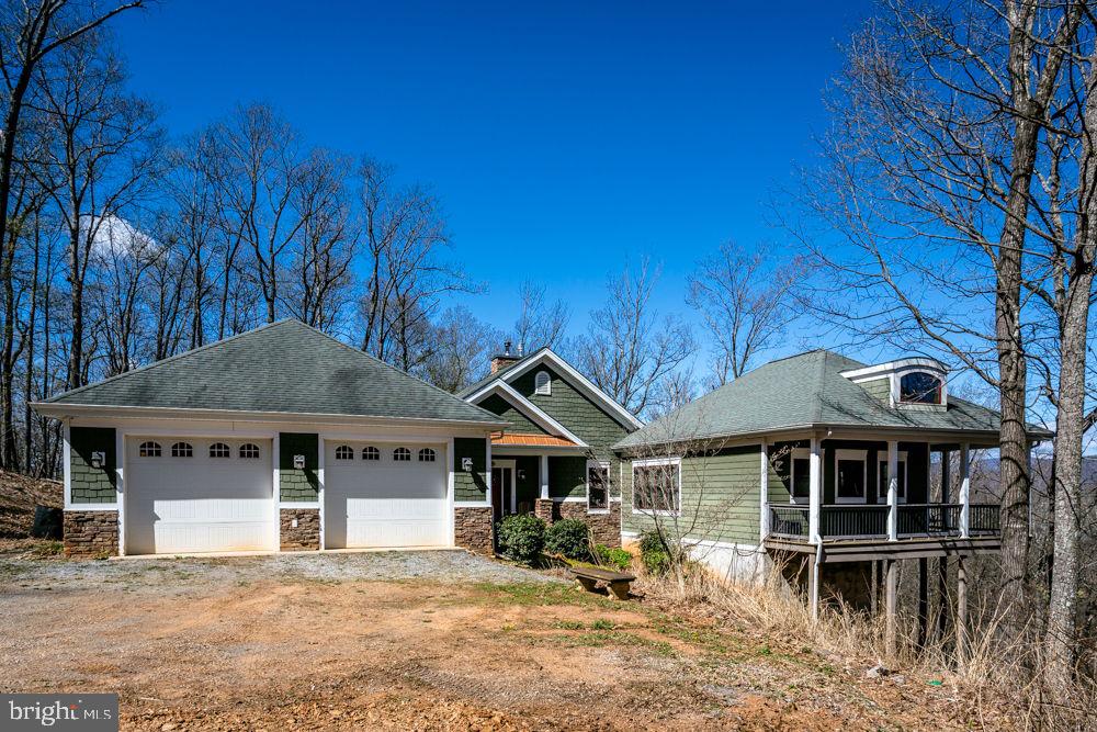 9586 Brunk Spring Lane Broadway, VA 22815 - Photo 52 of 57 a front view of a house with wooden fence and a tree