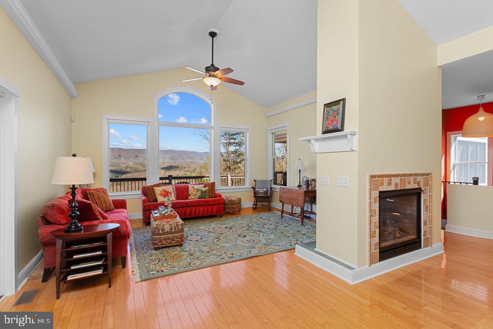 9586 Brunk Spring Lane Broadway, VA 22815 - Photo 6 of 57 a living room with furniture kitchen view and a chandelier