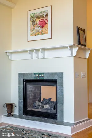 a living room with furniture kitchen view and a chandelier