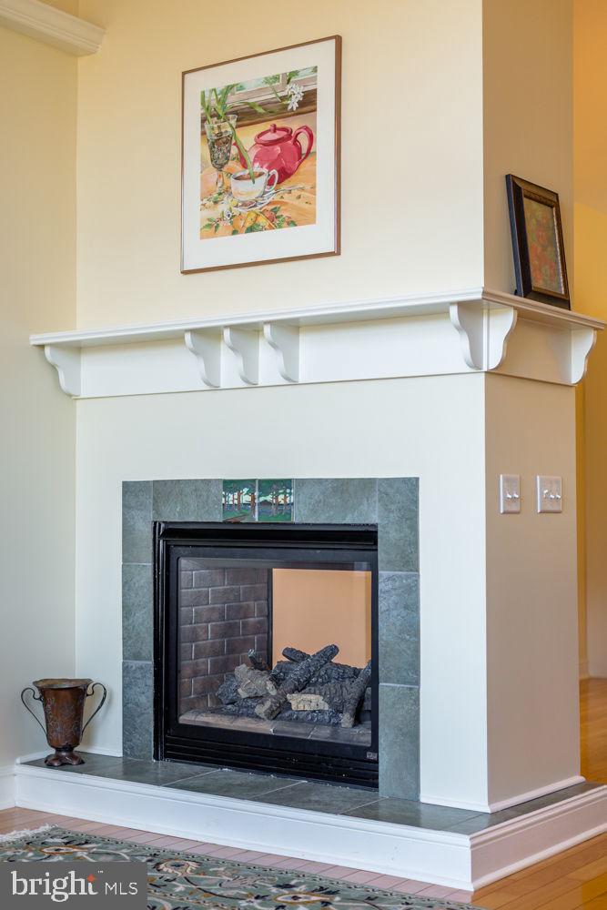 9586 Brunk Spring Lane Broadway, VA 22815 - Photo 7 of 57 a fireplace with a painting on the wall