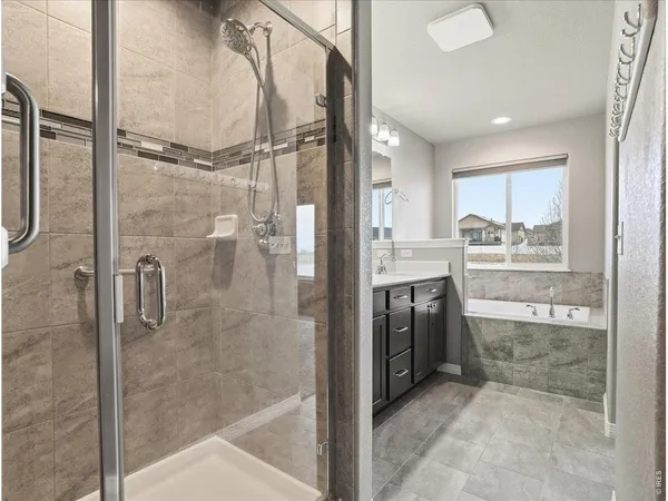 a bathroom with a bathtub and shower