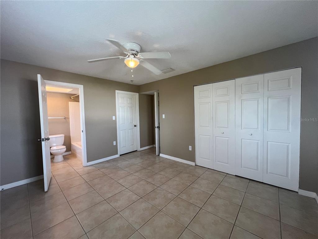 2704 2nd Street, Unit 16 Indian Rocks Beach, FL 33785 - Photo 12 of 23 an empty room with fan and entrance