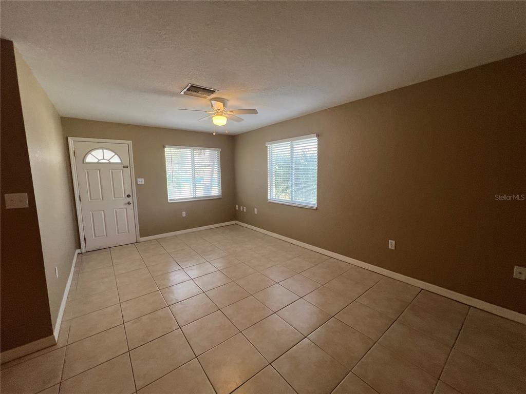 2704 2nd Street, Unit 16 Indian Rocks Beach, FL 33785 - Photo 5 of 23 an empty room with windows and closet
