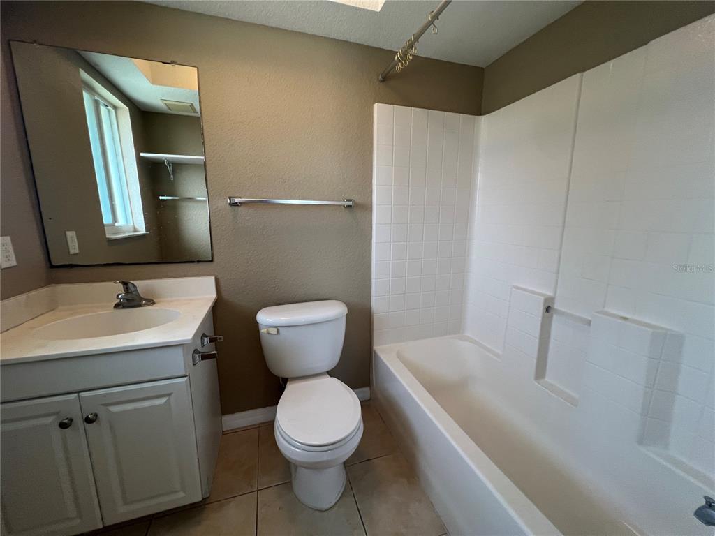 2704 2nd Street, Unit 16 Indian Rocks Beach, FL 33785 - Photo 9 of 23 a bathroom with a sink toilet and shower