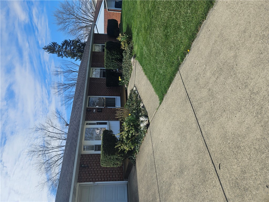6510 Longford Road Dayton, OH 45424 - Photo 2 of 27 This classic brick residence presents a welcoming facade with a well-maintained lawn and mature landscaping.