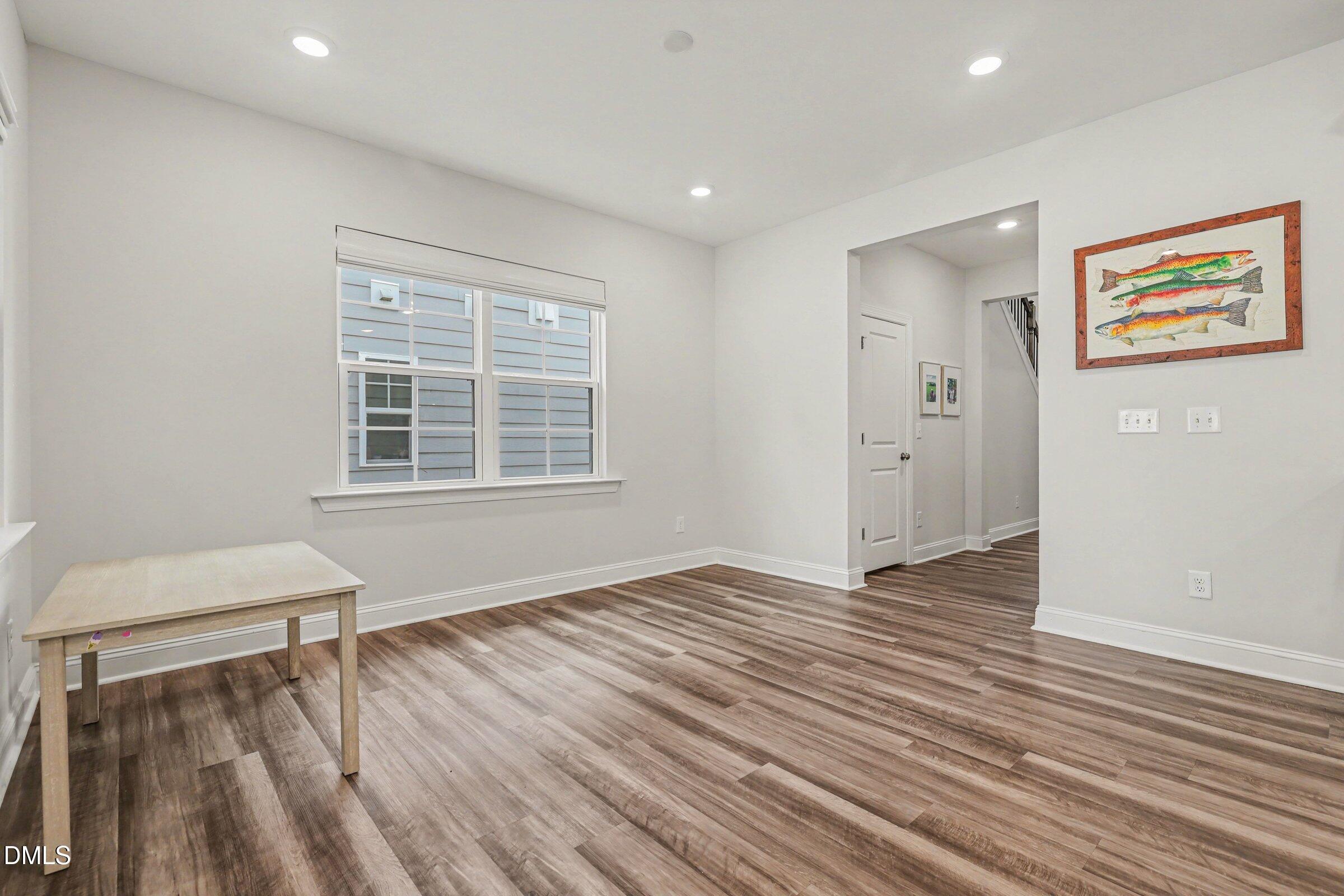4921 Abundance Avenue Raleigh, NC 27616 - Photo 13 of 36 a view of an empty room with wooden floor and a window