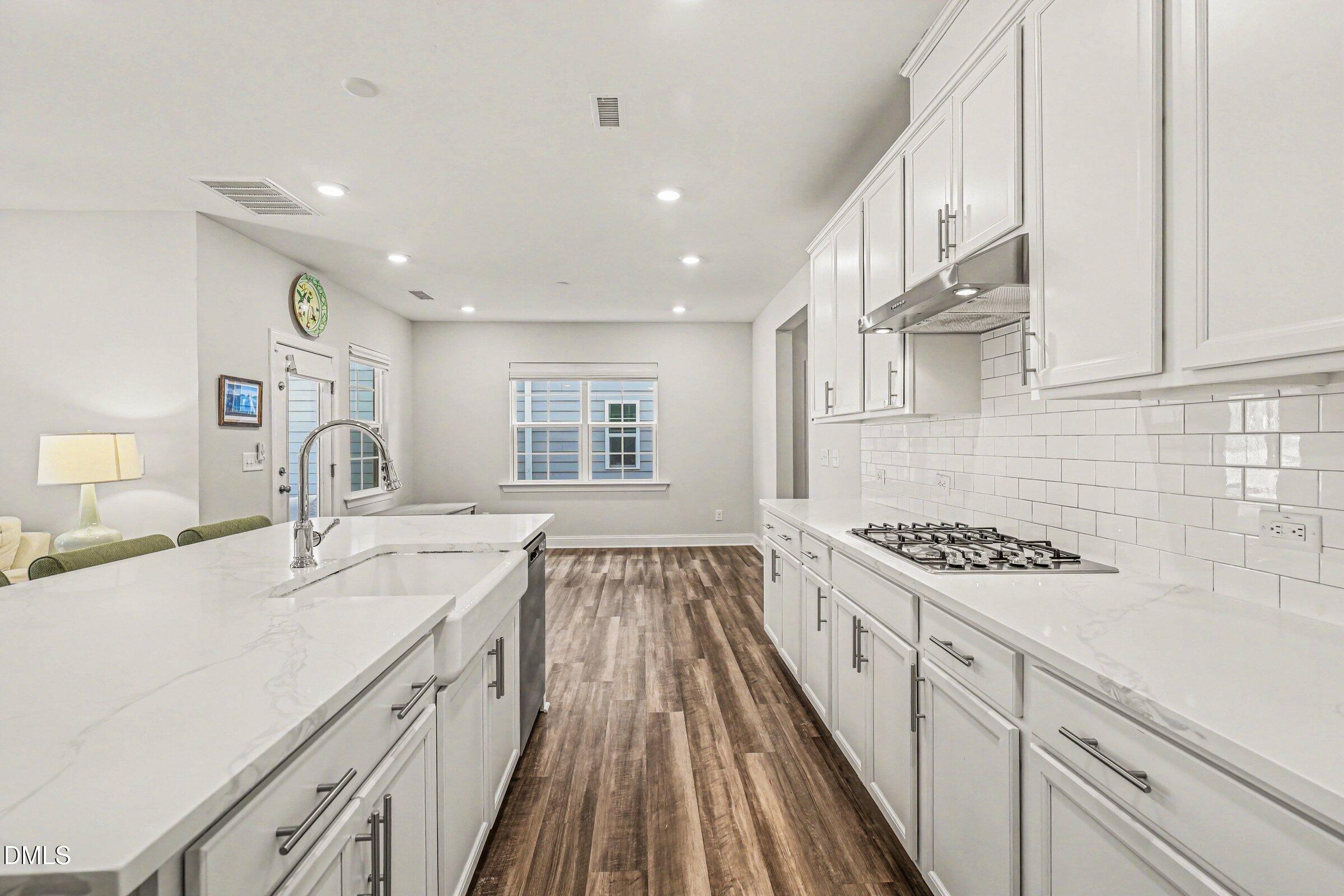 4921 Abundance Avenue Raleigh, NC 27616 - Photo 17 of 36 a kitchen with a sink stove and cabinets