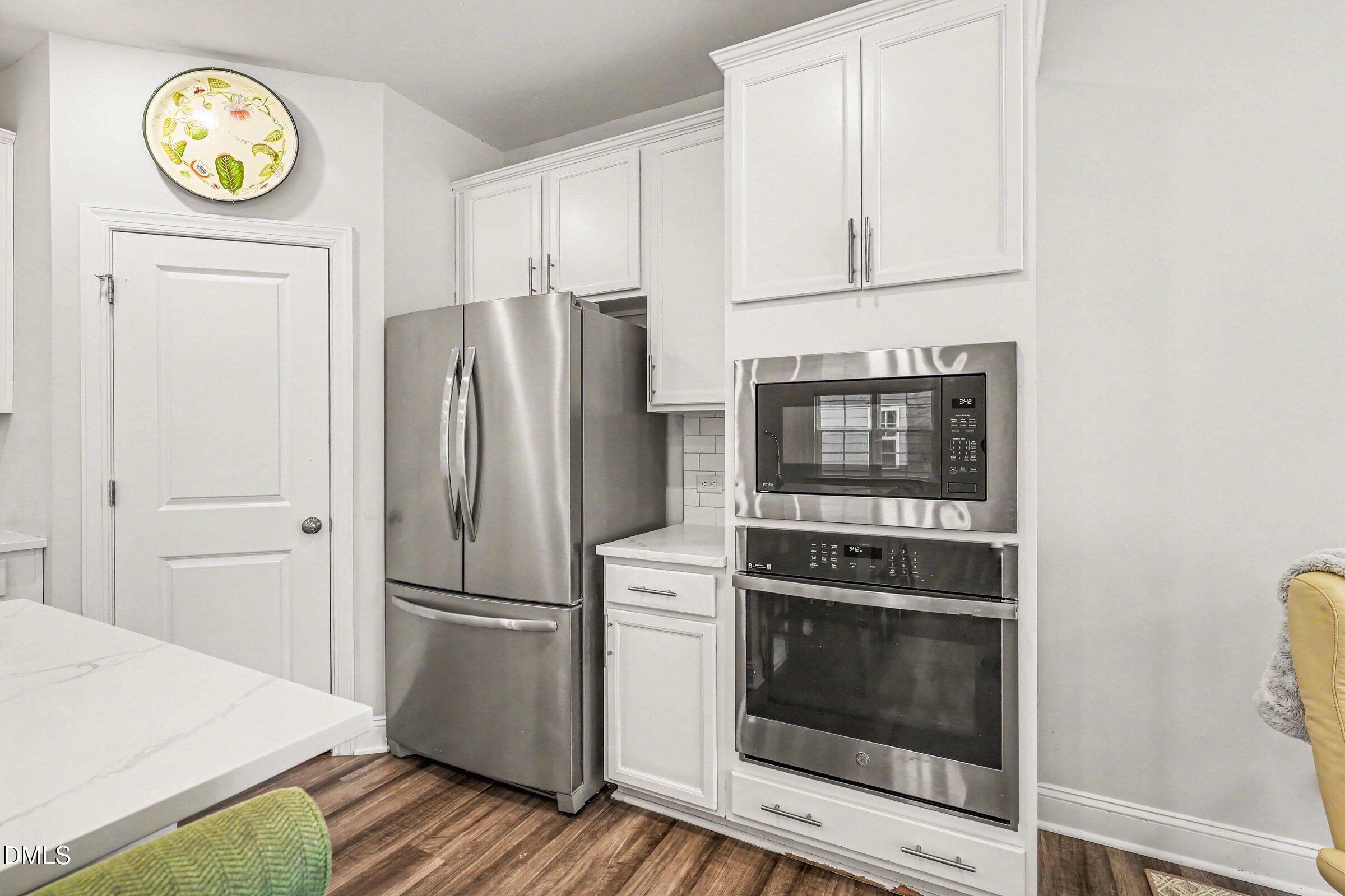4921 Abundance Avenue Raleigh, NC 27616 - Photo 18 of 36 a kitchen with a stove and a refrigerator