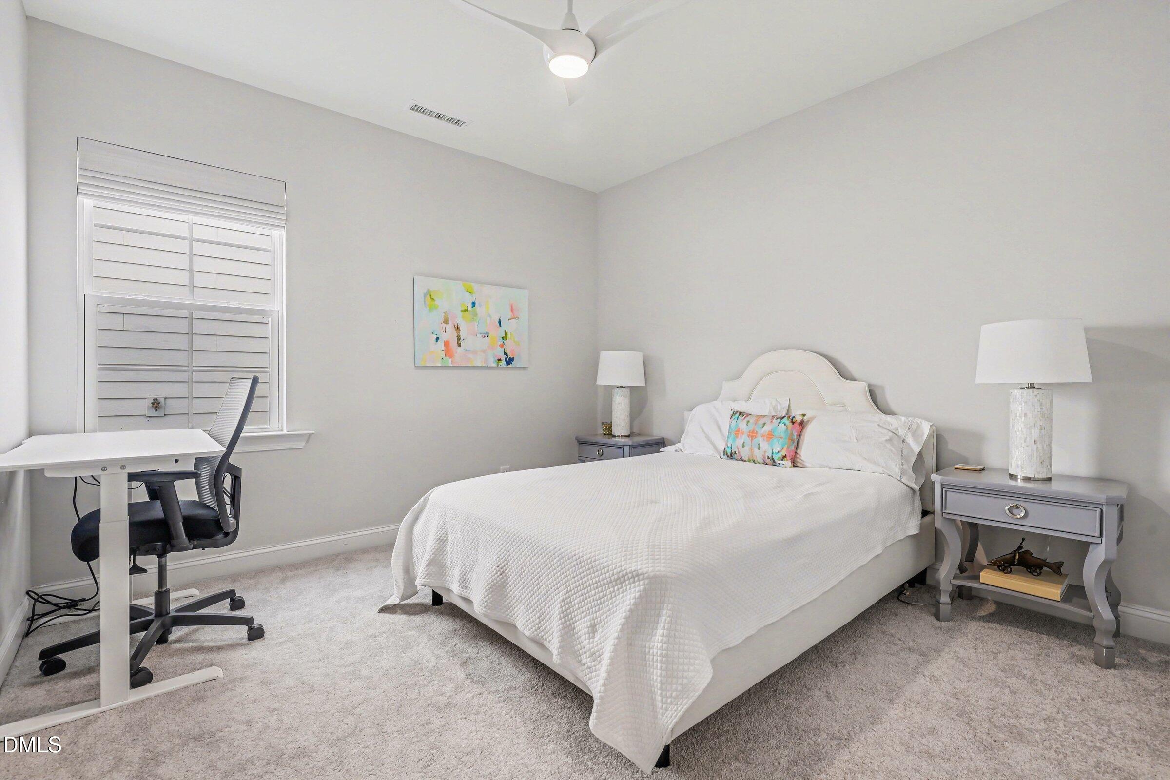 4921 Abundance Avenue Raleigh, NC 27616 - Photo 19 of 36 a bedroom with a bed a desk and chair
