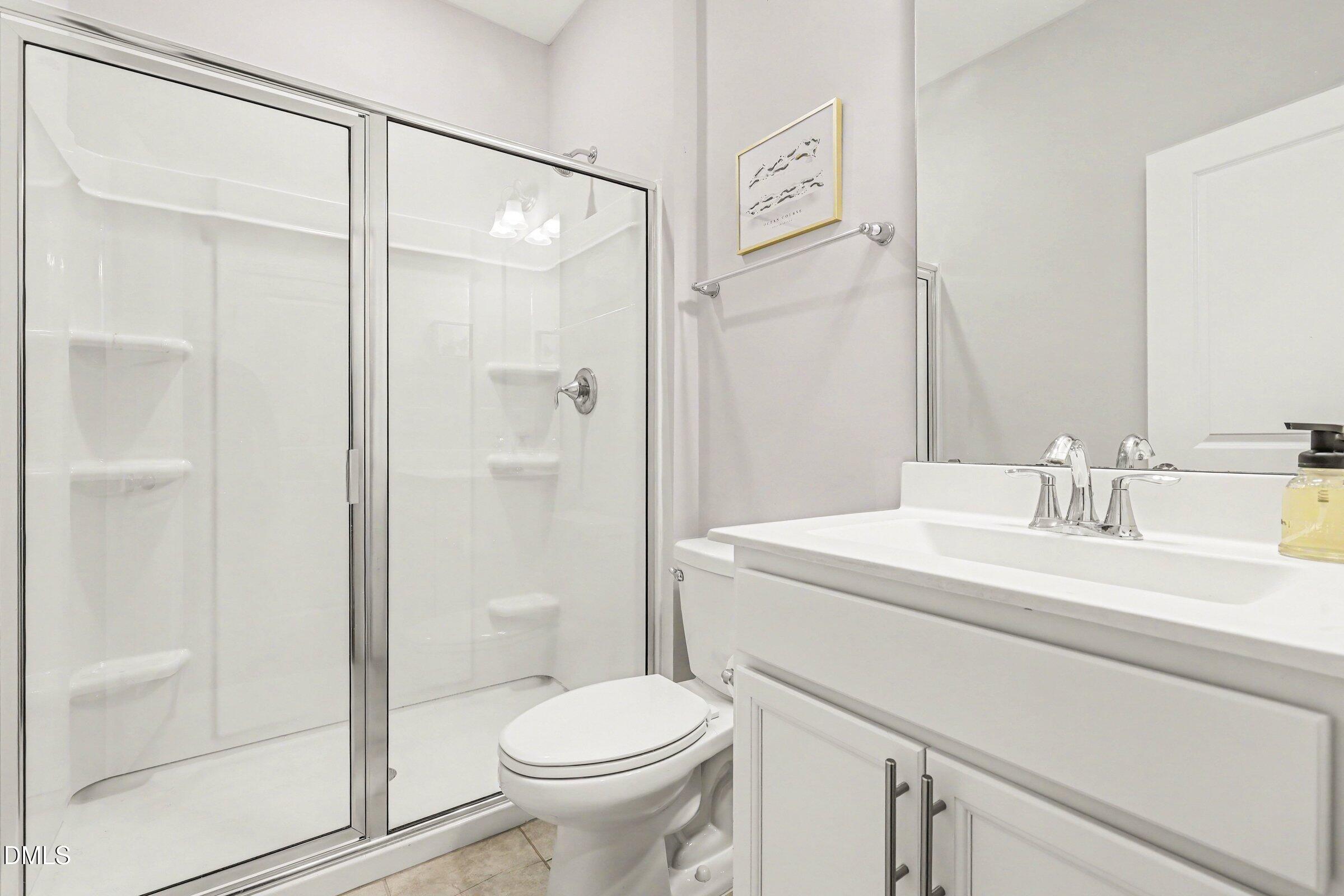 4921 Abundance Avenue Raleigh, NC 27616 - Photo 20 of 36 a bathroom with a sink a toilet and shower