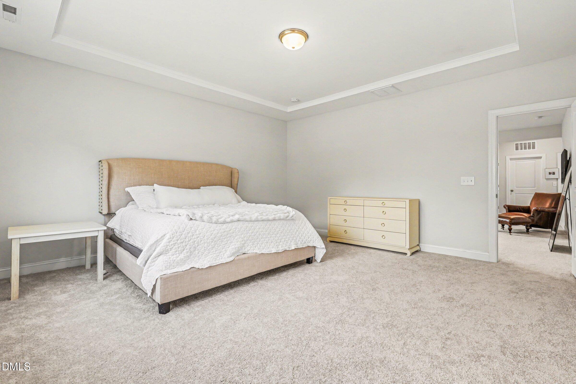 4921 Abundance Avenue Raleigh, NC 27616 - Photo 22 of 36 a bedroom with a bed and a chair
