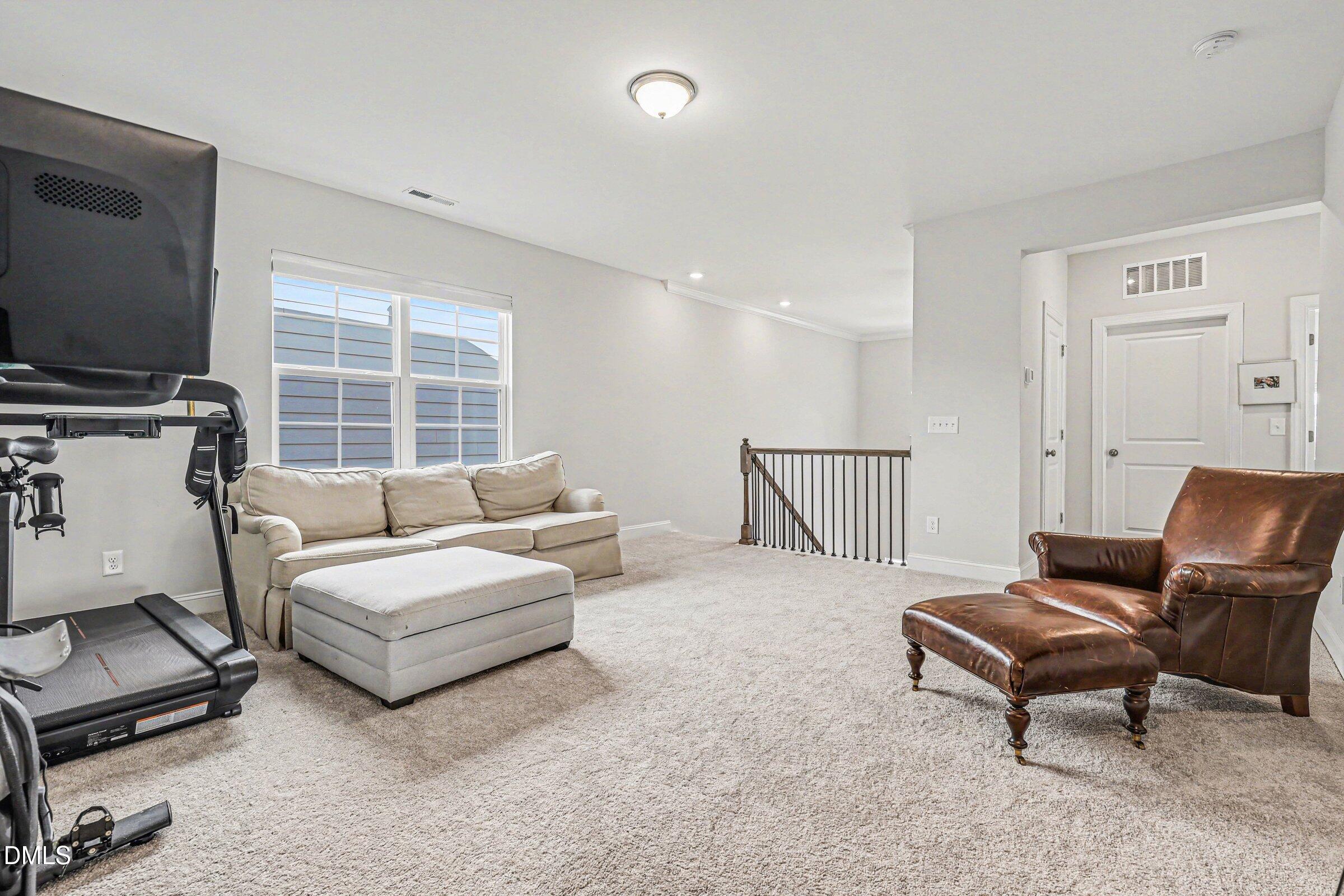 4921 Abundance Avenue Raleigh, NC 27616 - Photo 25 of 36 a bedroom with furniture and a flat screen tv