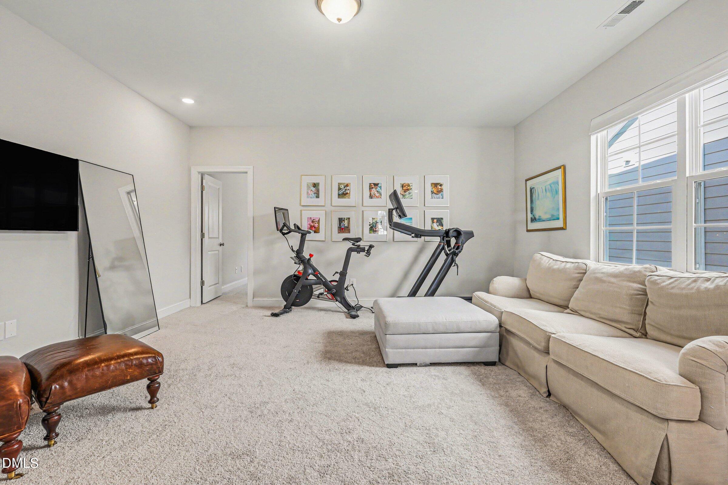 4921 Abundance Avenue Raleigh, NC 27616 - Photo 26 of 36 a living room with furniture and a flat screen tv