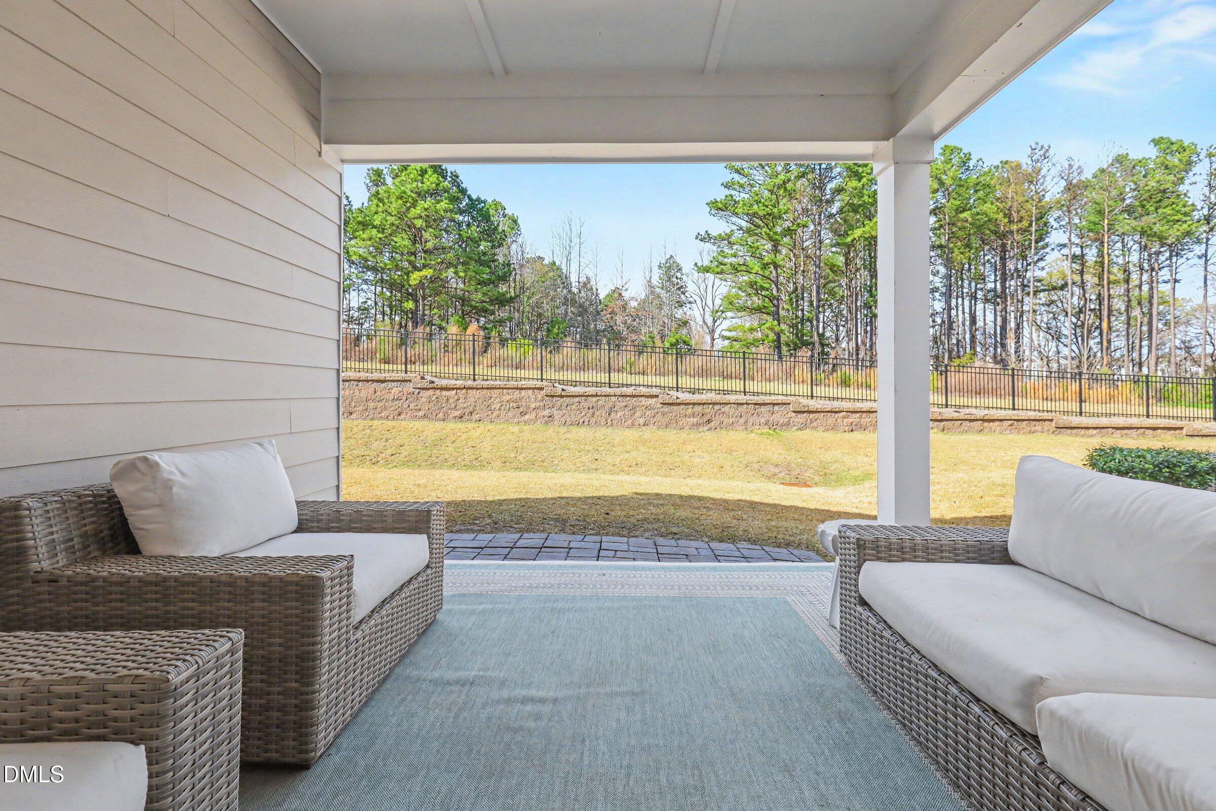 4921 Abundance Avenue Raleigh, NC 27616 - Photo 31 of 36 a living room with furniture and a floor to ceiling window