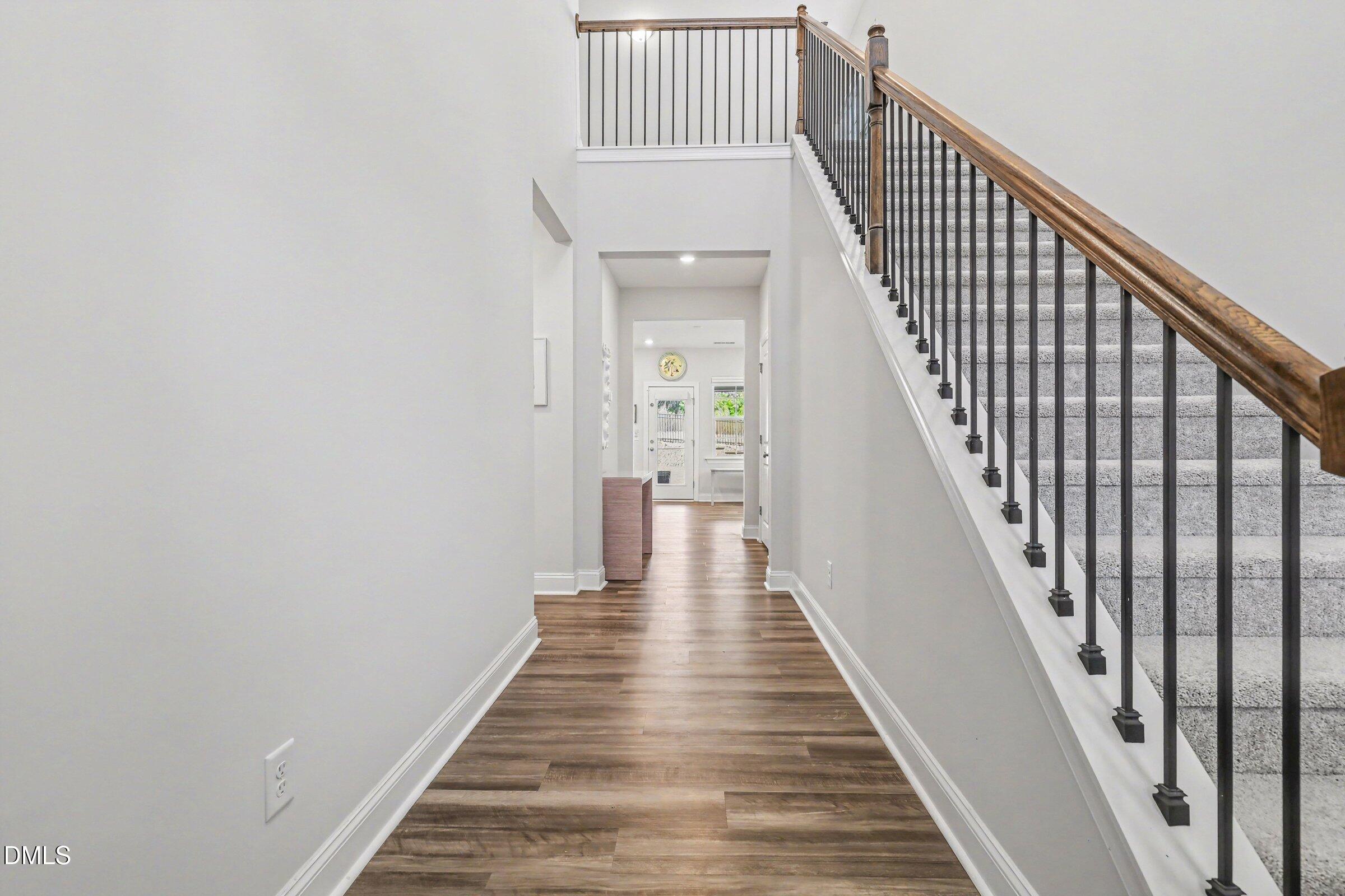 4921 Abundance Avenue Raleigh, NC 27616 - Photo 3 of 36 a view of a hallway with wooden floor and staircase