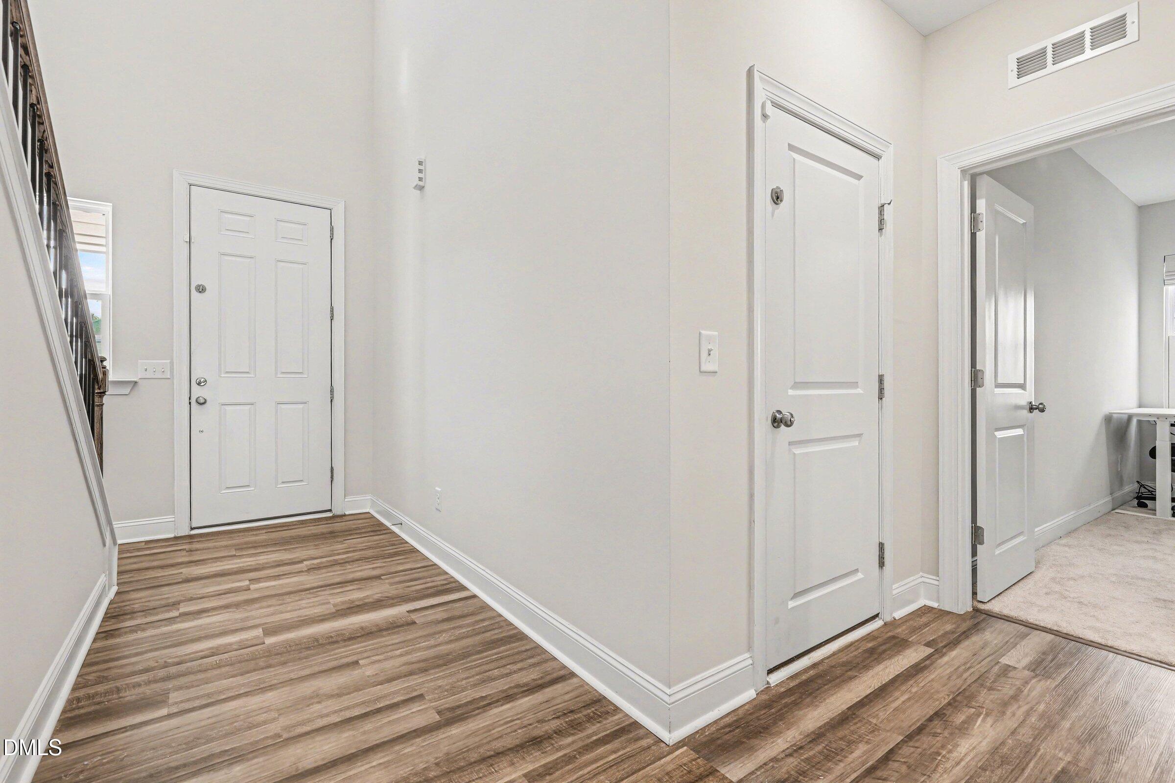 4921 Abundance Avenue Raleigh, NC 27616 - Photo 4 of 36 a view of a hallway with wooden floor and closet area