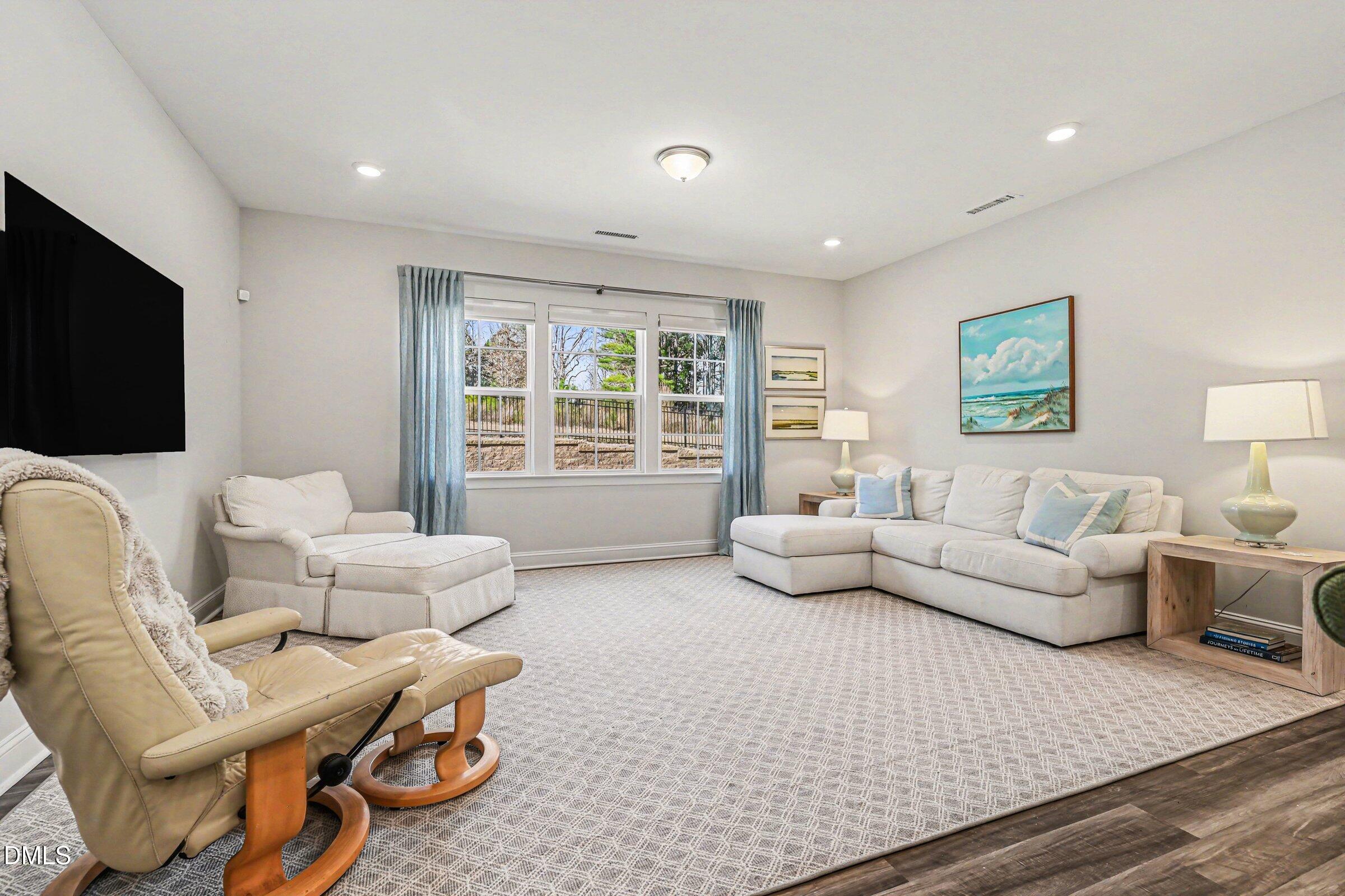 4921 Abundance Avenue Raleigh, NC 27616 - Photo 5 of 36 a living room with furniture and a flat screen tv