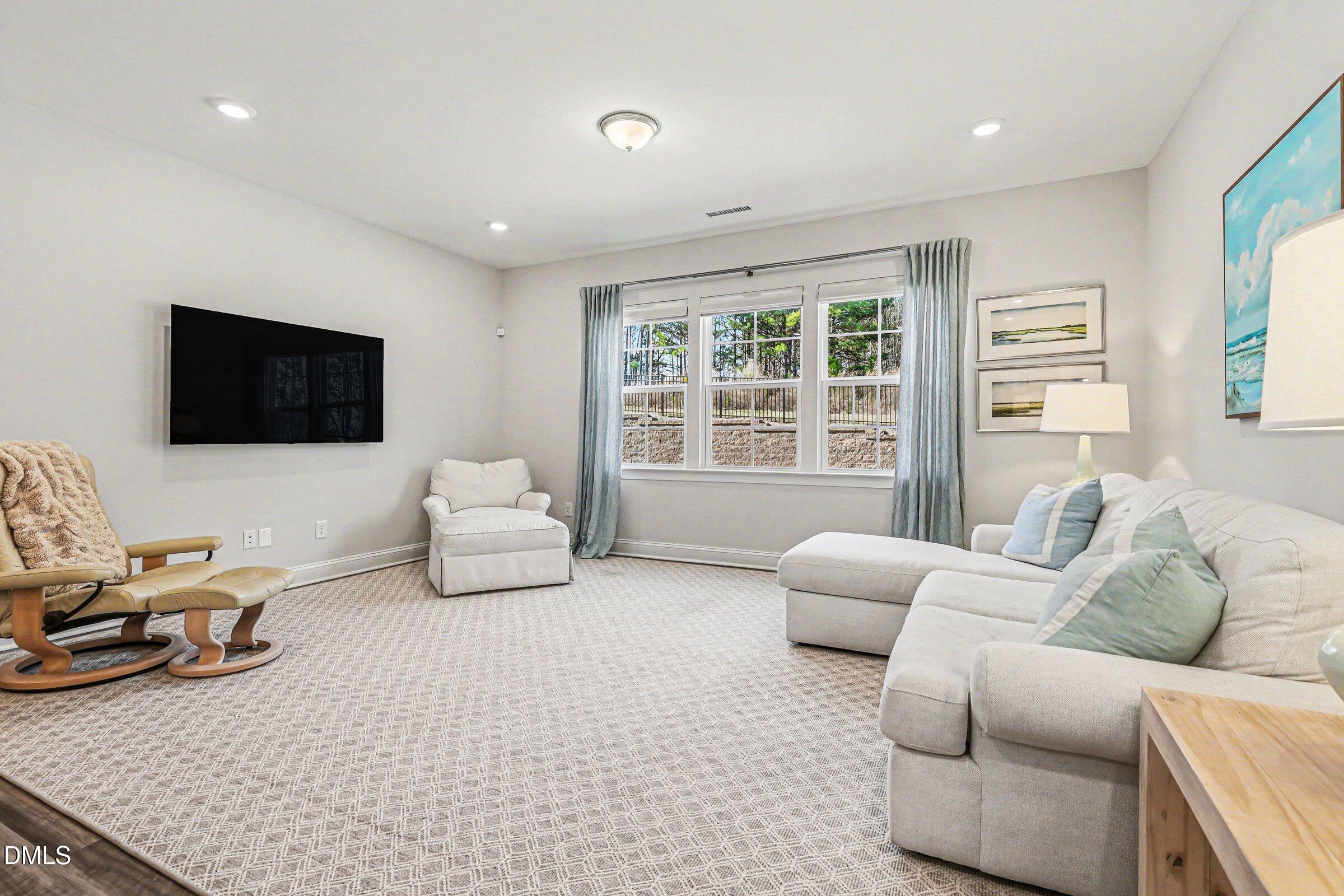 4921 Abundance Avenue Raleigh, NC 27616 - Photo 7 of 36 a living room with furniture and a flat screen tv