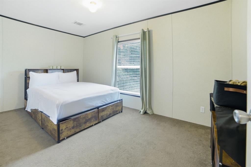 127 Almond Road Minden, LA 71055 - Photo 20 of 25 a bed sitting in a room next to a window