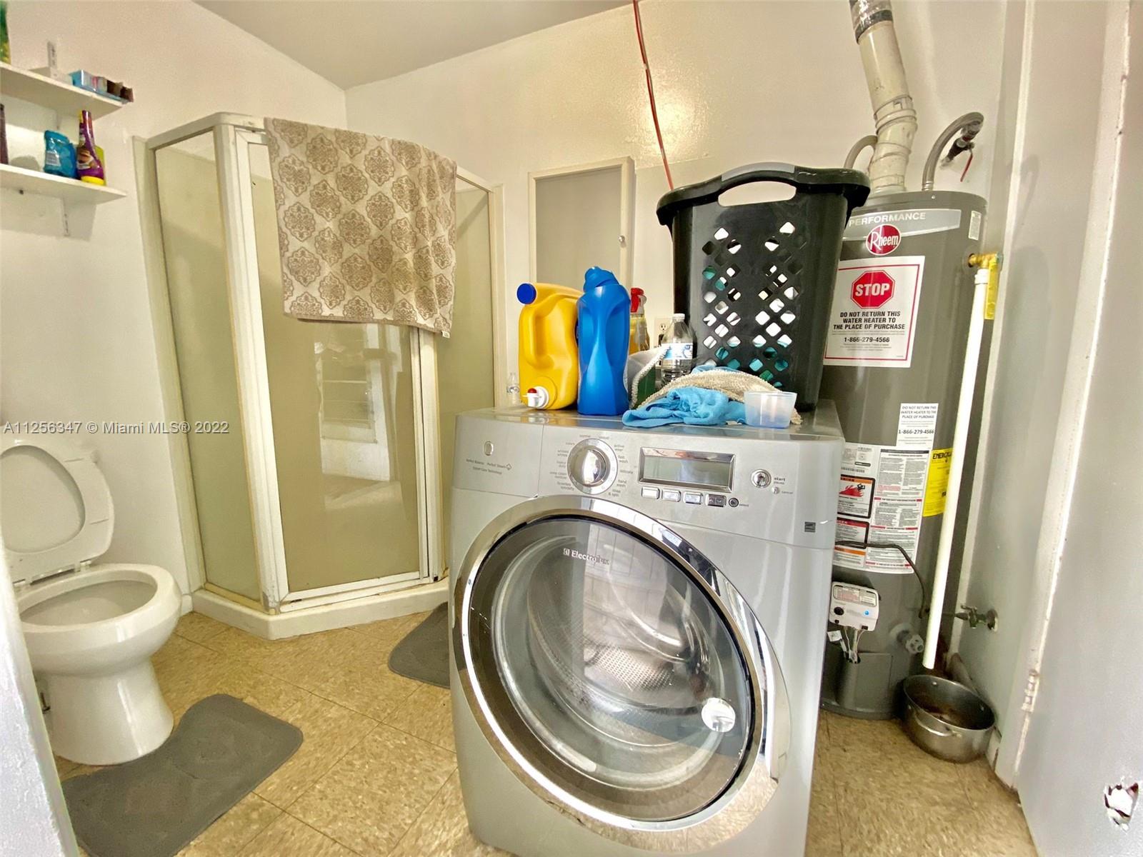 1305 Drexel Road West Palm Beach, FL 33417 - Photo 14 of 20 a bathroom with a sink toilet and shower