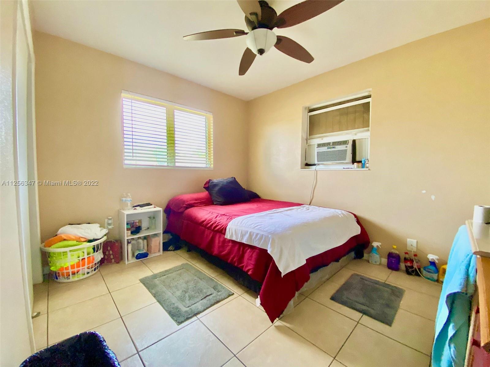 1305 Drexel Road West Palm Beach, FL 33417 - Photo 15 of 20 a bedroom with a bed and a chandelier