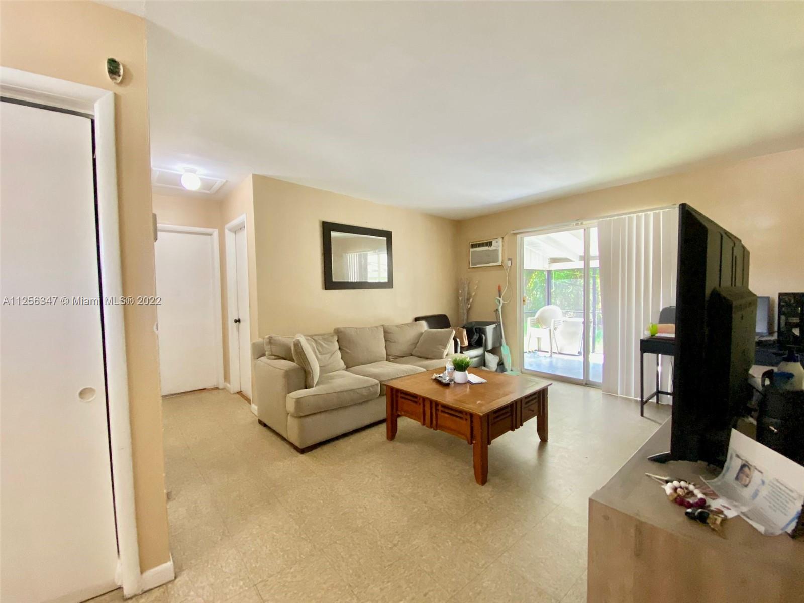 1305 Drexel Road West Palm Beach, FL 33417 - Photo 4 of 20 a living room with furniture and a flat screen tv