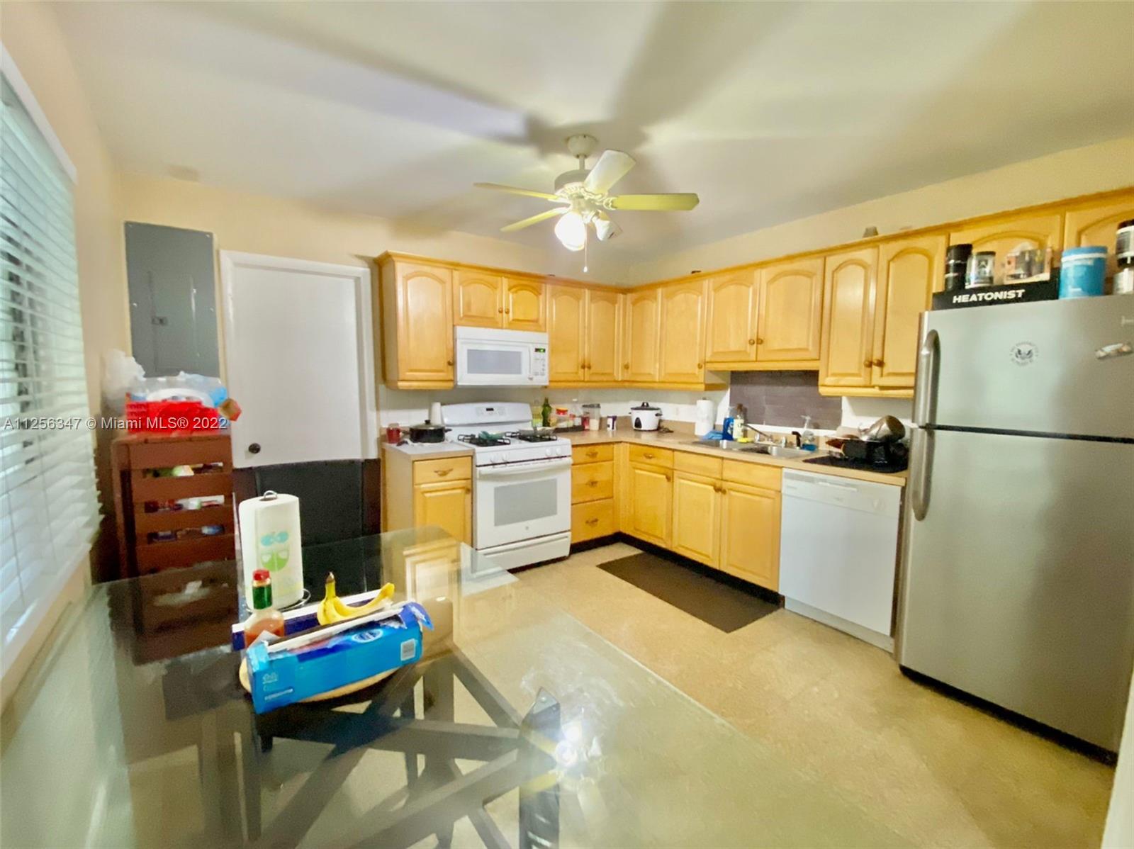 1305 Drexel Road West Palm Beach, FL 33417 - Photo 6 of 20 a kitchen with granite countertop stainless steel appliances and white cabinets