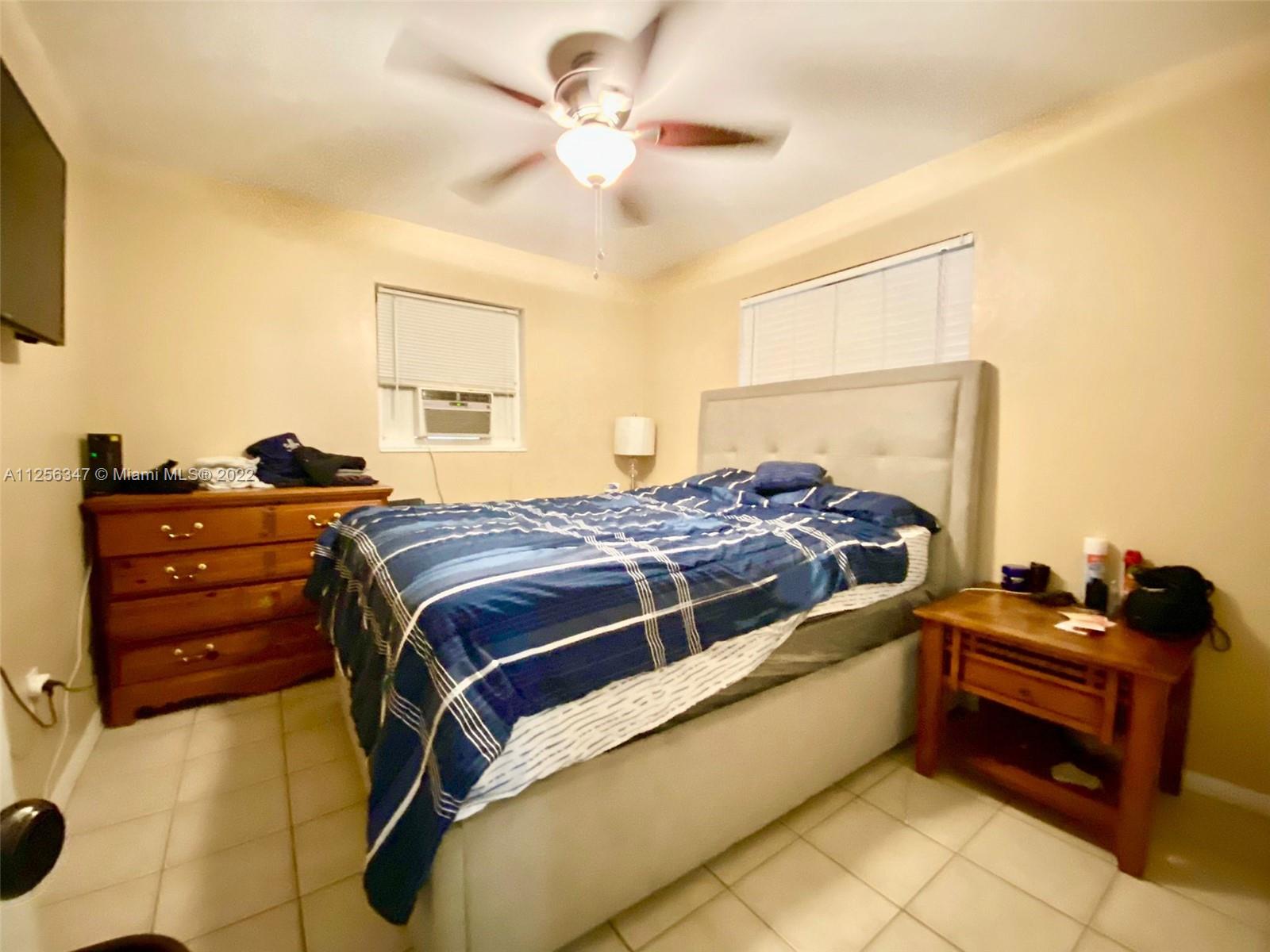 1305 Drexel Road West Palm Beach, FL 33417 - Photo 7 of 20 a bedroom with a bed and a chandelier