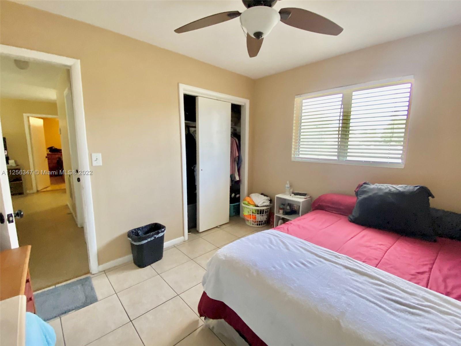 1305 Drexel Road West Palm Beach, FL 33417 - Photo 8 of 20 a bedroom with a bed and a chandelier
