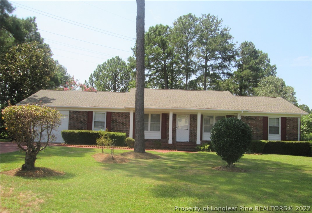 2246 Shaw Rd Extension Fayetteville, NC 28311 - Photo 1 of 15 a view of a house with a yard deck and a large tree