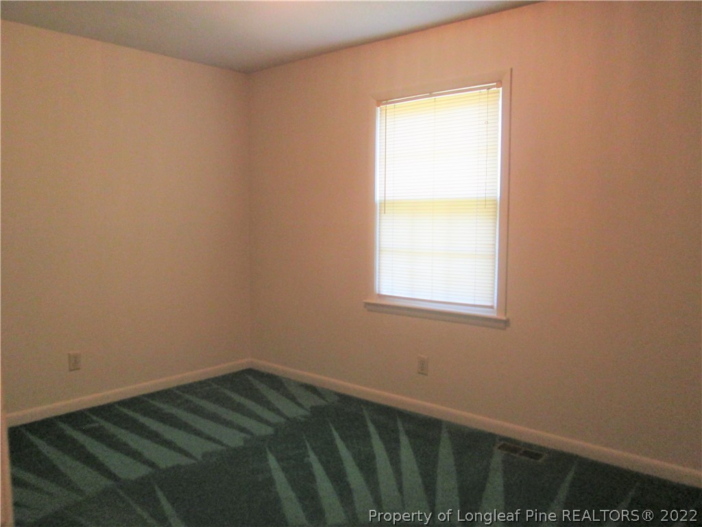 2246 Shaw Rd Extension Fayetteville, NC 28311 - Photo 6 of 15 a view of a room with wooden floor and a window