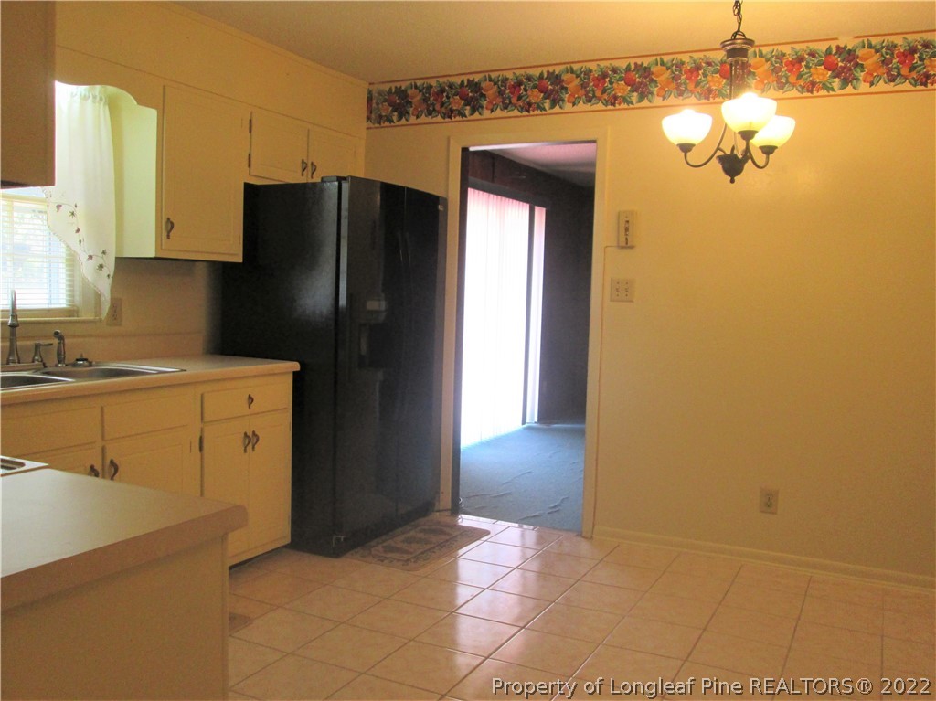 2246 Shaw Rd Extension Fayetteville, NC 28311 - Photo 10 of 15 a kitchen with a refrigerator and a sink