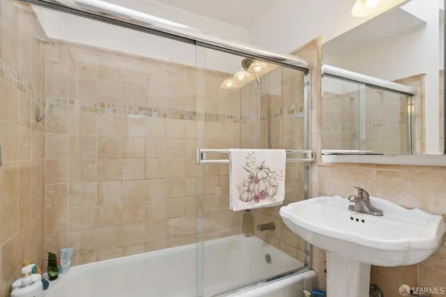 a spacious bedroom with a bed and a chair in it