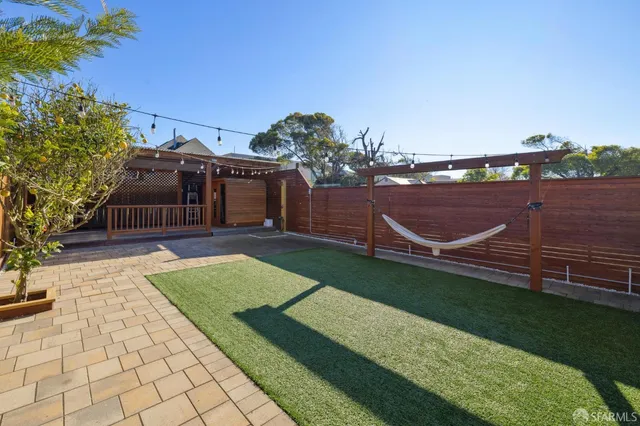 a view of a backyard with sitting area