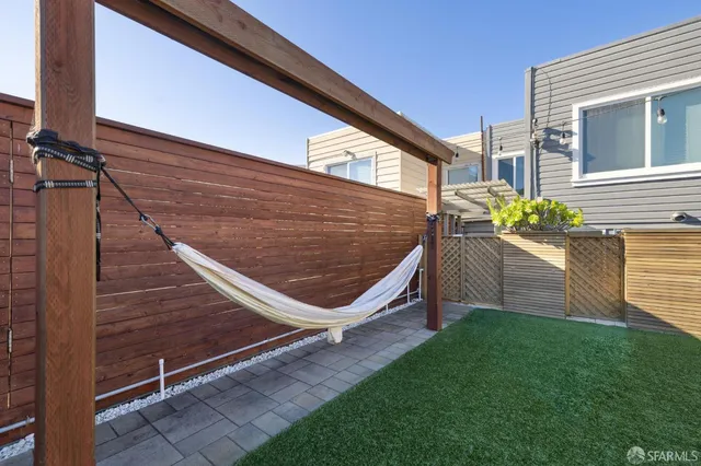 a view of a backyard with sitting area