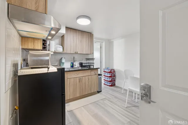 a kitchen with granite countertop a refrigerator stove and sink