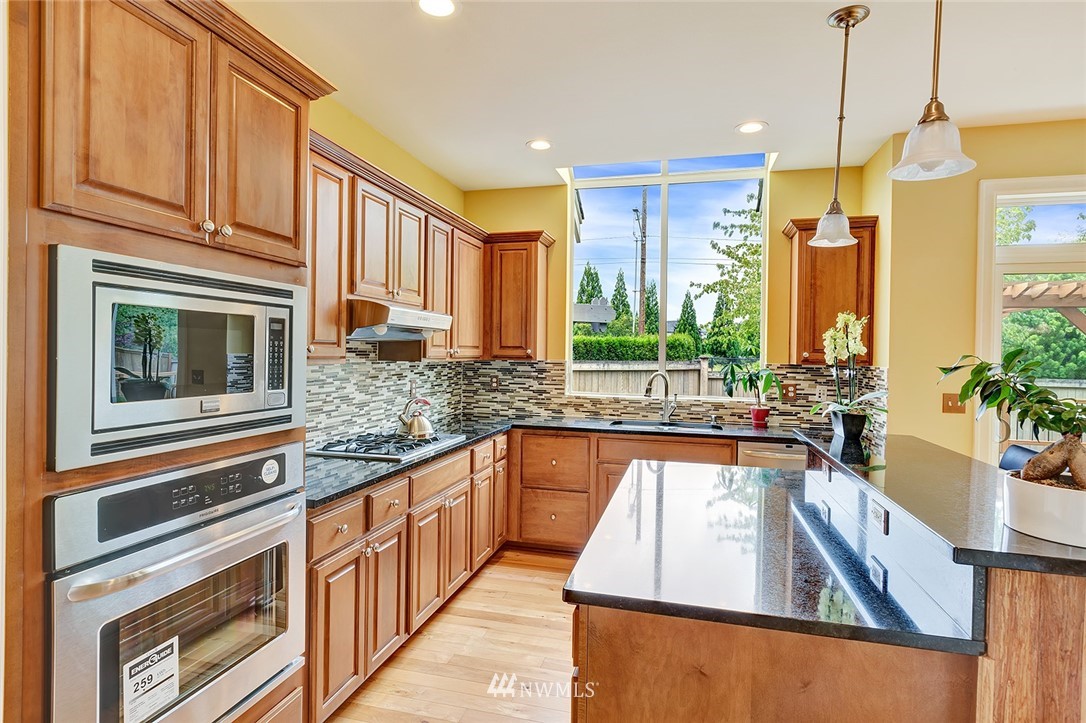 3617 156th Place Southeast Bothell, WA 98012 - Photo 5 of 18 a kitchen with stainless steel appliances granite countertop a stove a sink and a refrigerator