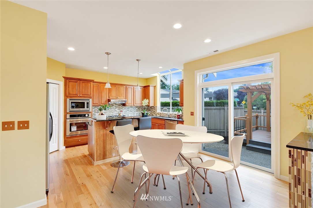 3617 156th Place Southeast Bothell, WA 98012 - Photo 6 of 18 a dining room with stainless steel appliances a dining table and chairs
